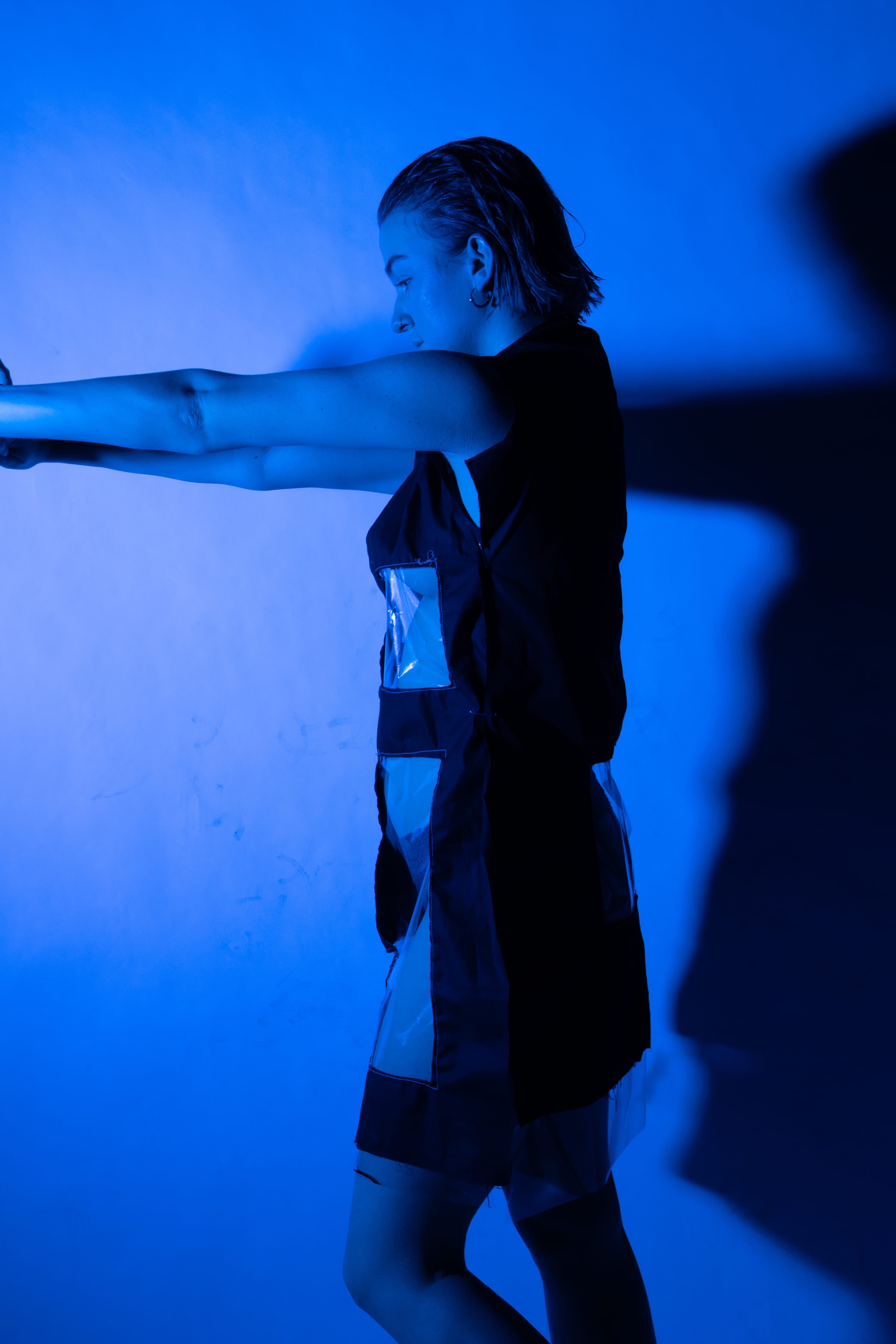 picture of someone in blue light, in a partially see through dress