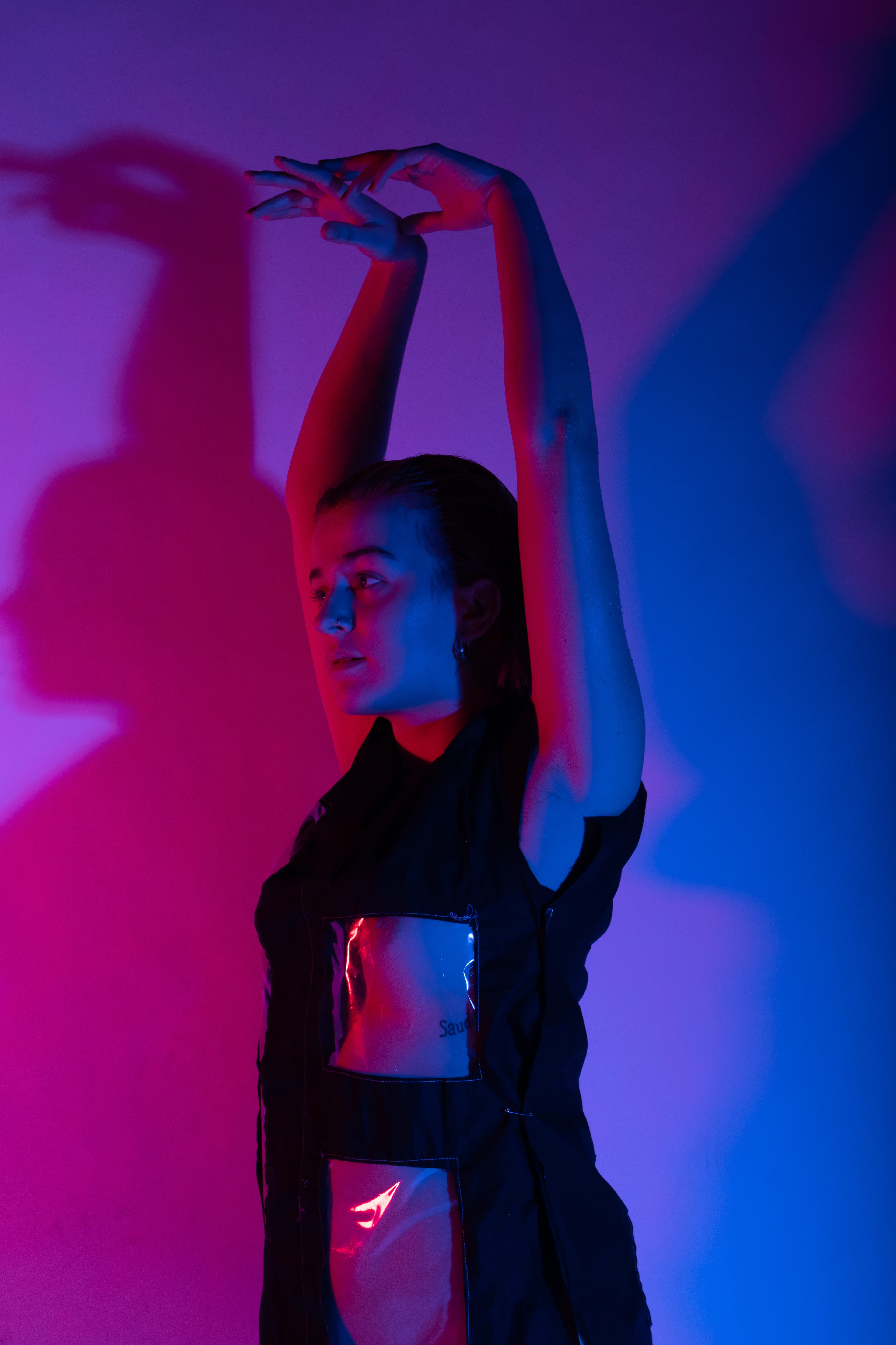 colourfull image of woman in see through dress with hands stretched out above her head